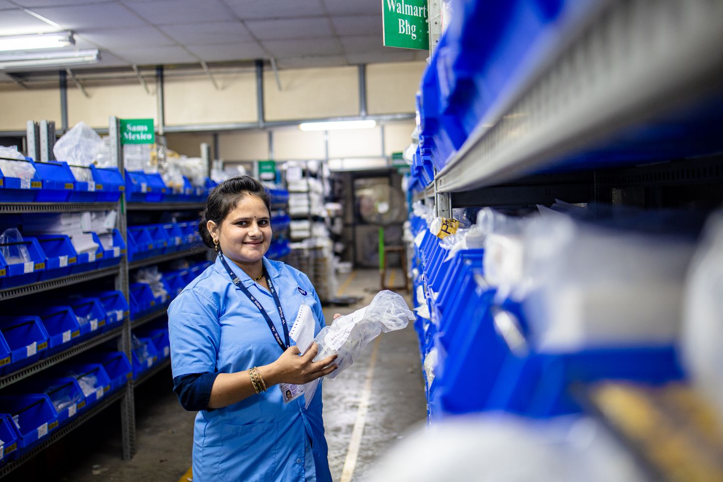 Warehouse worker organising inventory in a storage facility.